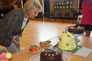 woman looking at a table full of cakes