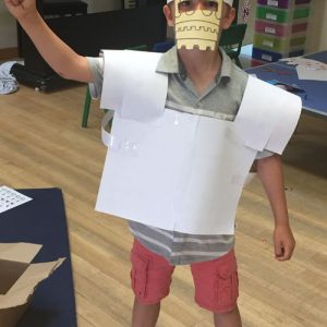 student with paper mask over face