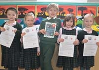 students holding their certificates for art