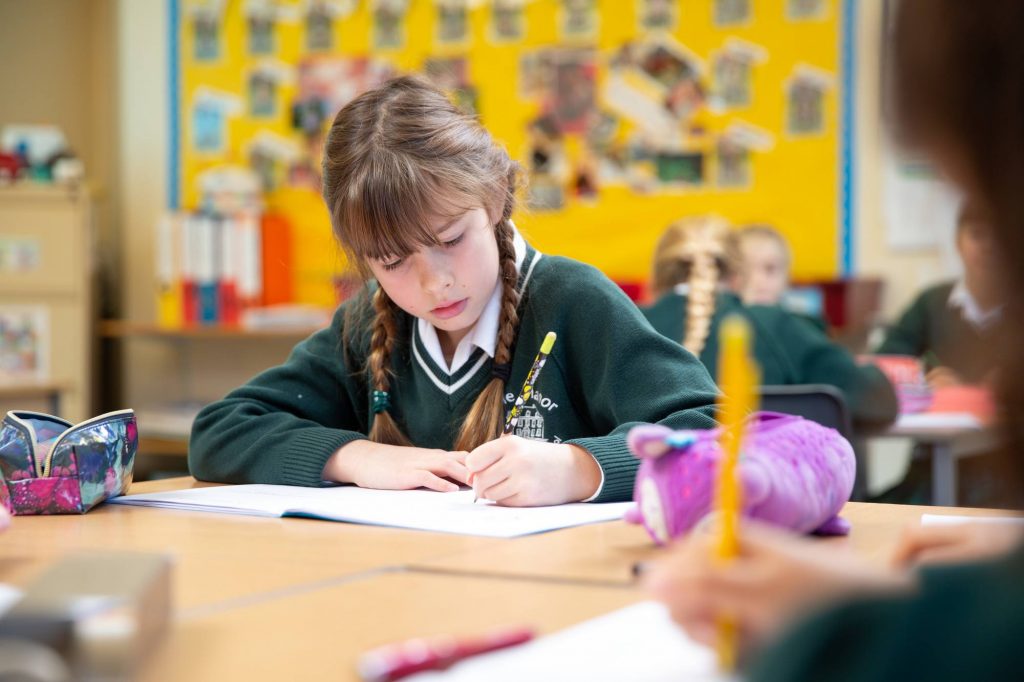 Prep School Child Writing in Their Booklet