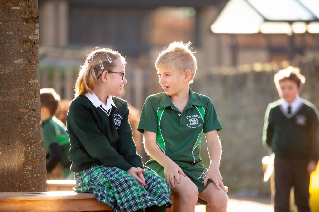 2 Manor Prep students having a conversation outside