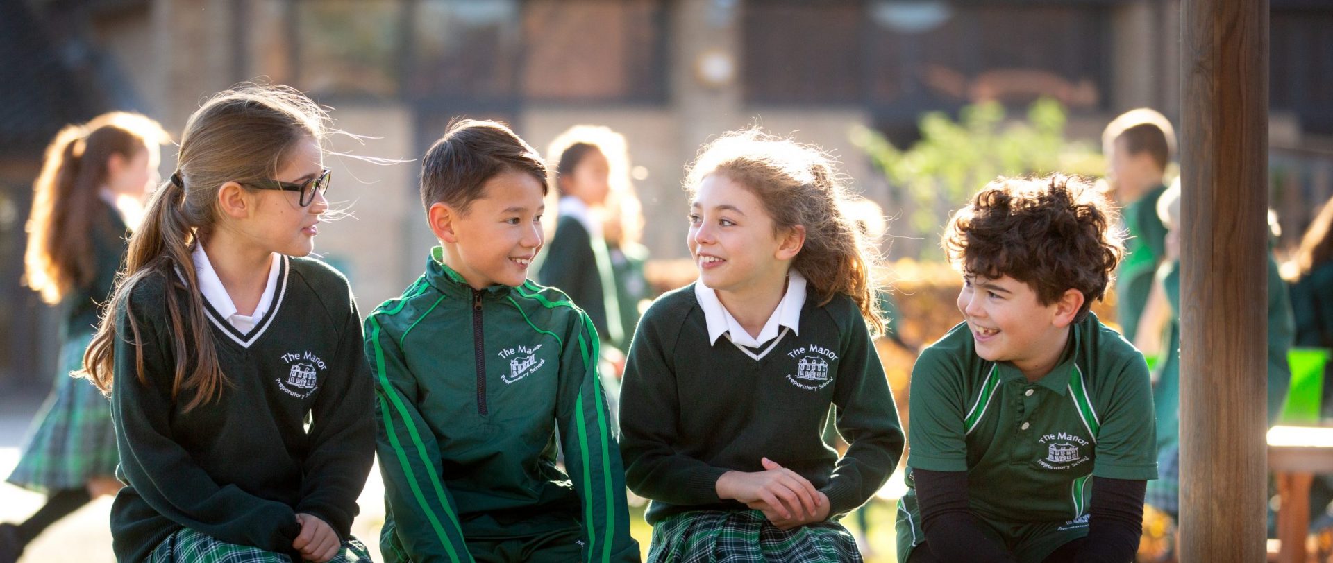 4 Manor Prep students sat on a bench