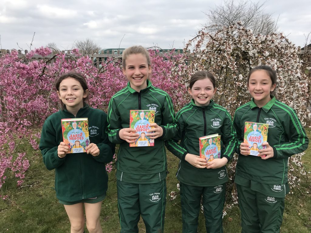 girls holding books in their hands