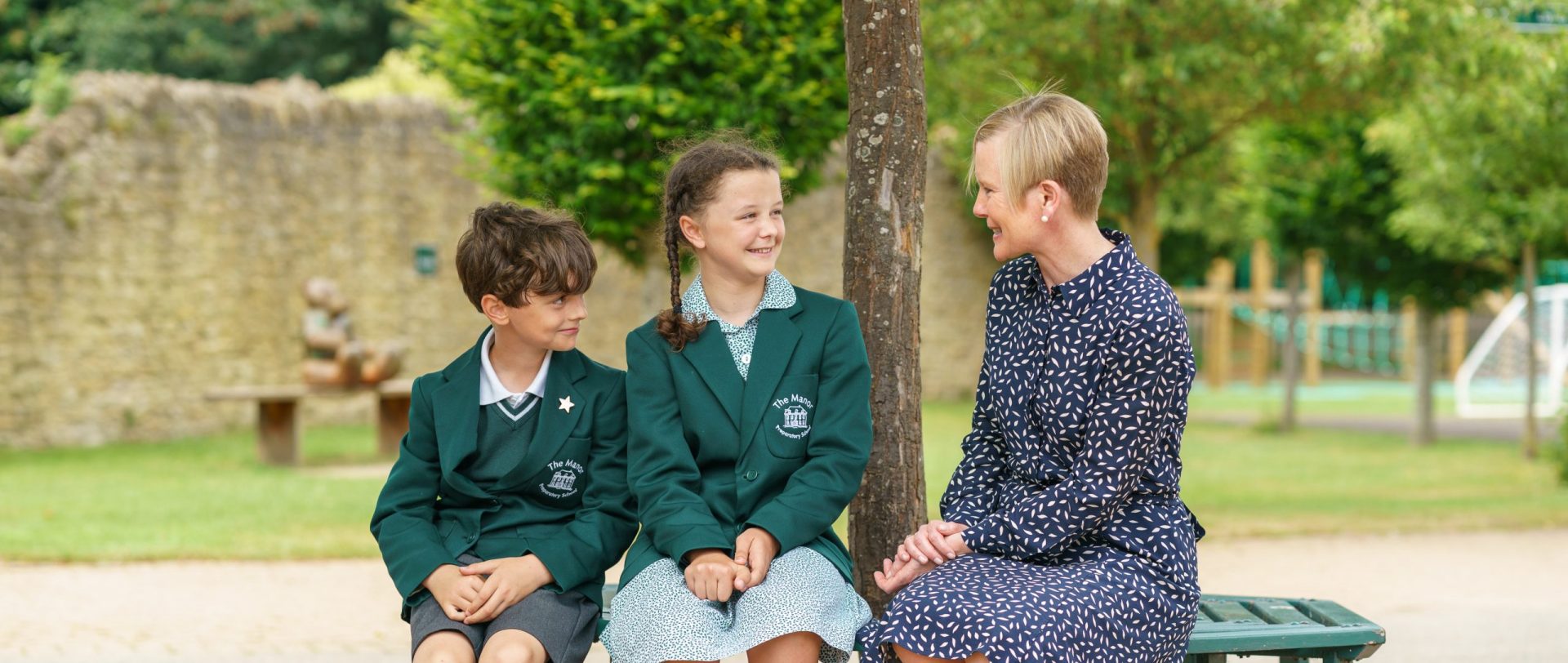 2 students talking to a teacher