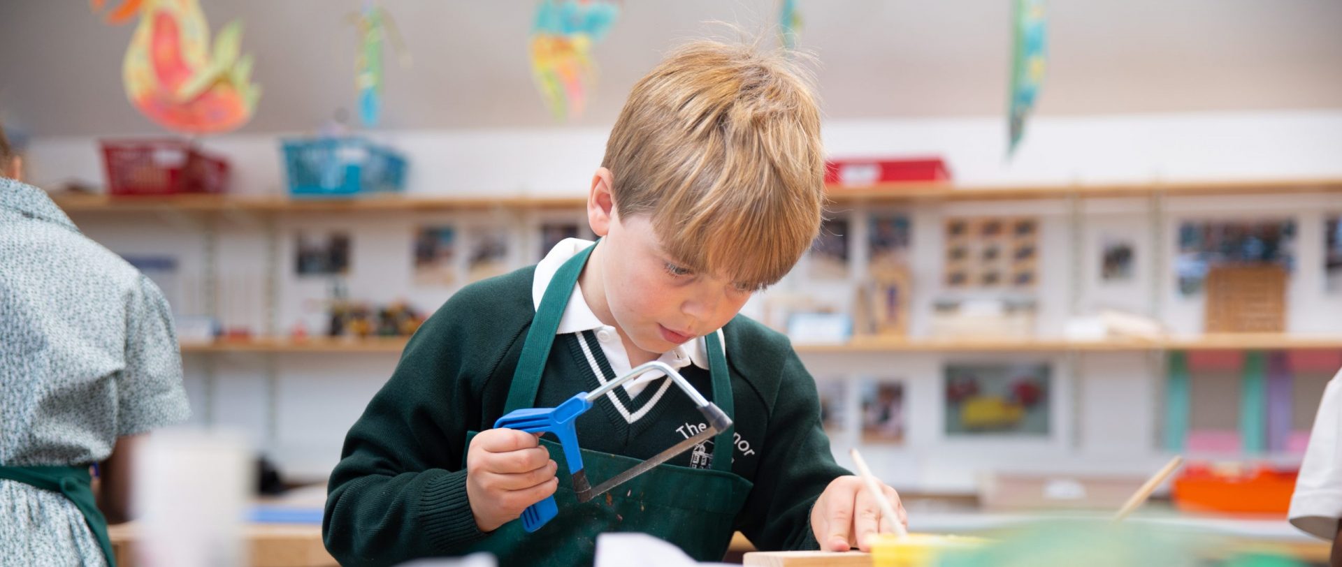 student using a hand saw