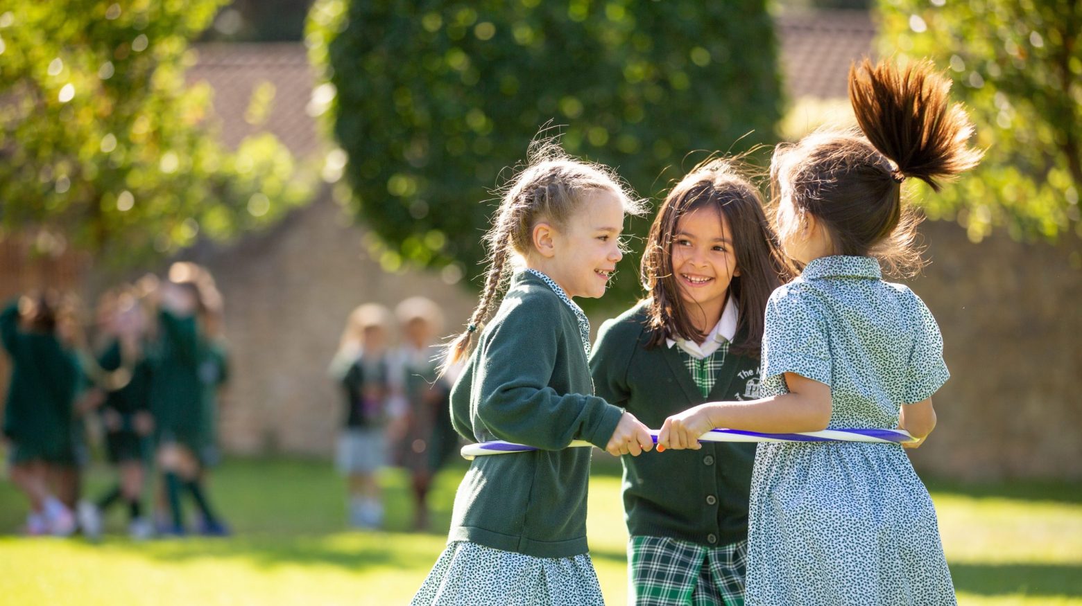 girls playing with a hoop