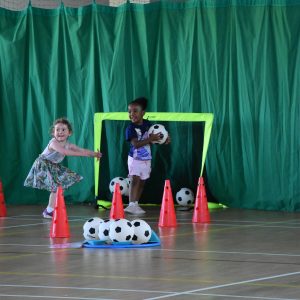 Students playing indoors football