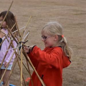 students helping with a tent build