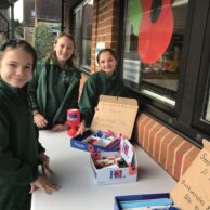students at a table of buttons and badges