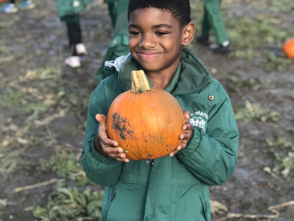 student holding a pumpkin