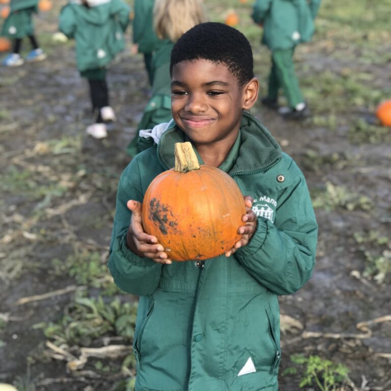 student holding a pumpkin
