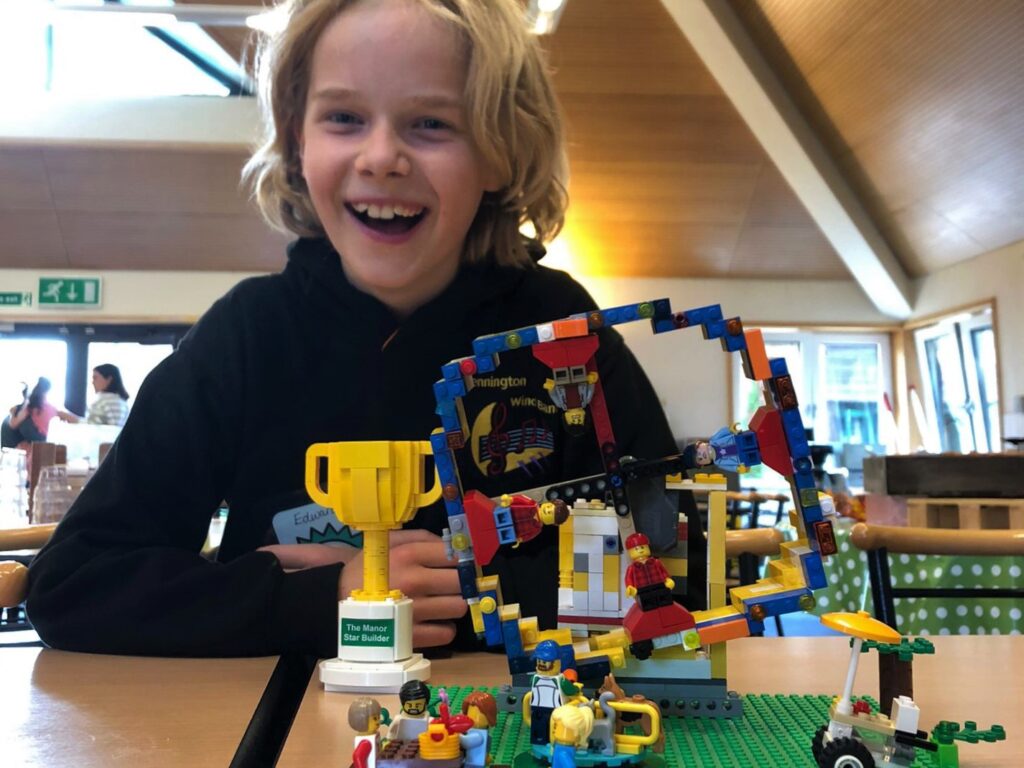 student showing off his lego creation